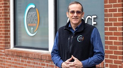 Jamie Munyon, an alum of SUNY Adirondack and director of Open Door, stands outside the facility