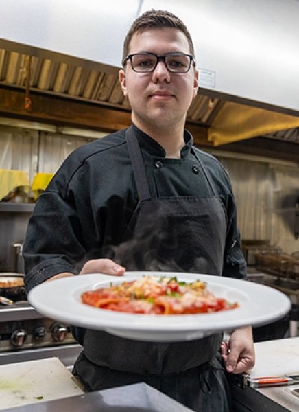 Patrick Fayette displays a dish he made at Radici in downtown Glens Falls