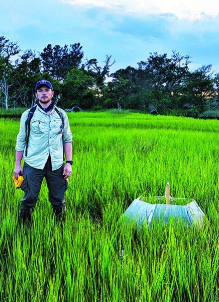 SUNY Adirondack alum David De La Mater is seen in a salt marsh, where he conducts research for Duke University