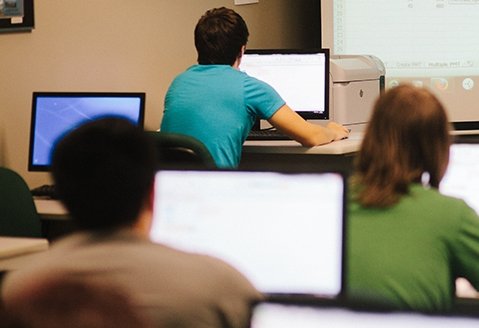 Students work on computers in a classroom