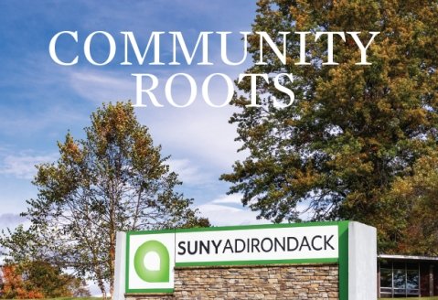 Cover image of Fall 2024 Community Roots issue, fall leaves on trees by the SUNY Adirondack sign