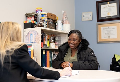 Distinguished Professor of Business Kelli Hatin meets with a student