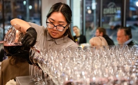 A Culinary student pours wine at Vintners Night at Seasoned