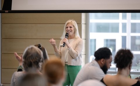 President Kristine D. Duffy, Ed.D., speaks to a group of students on campus.