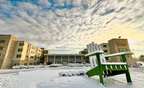 The Residence Hall is seen from the western entrance to campus on a sunny winter day