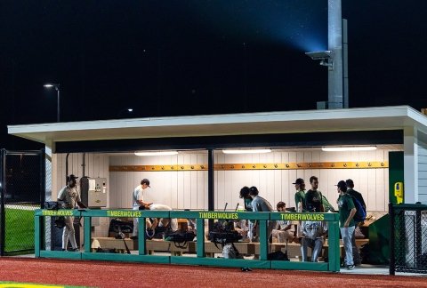 Baseball team in the dugout at night