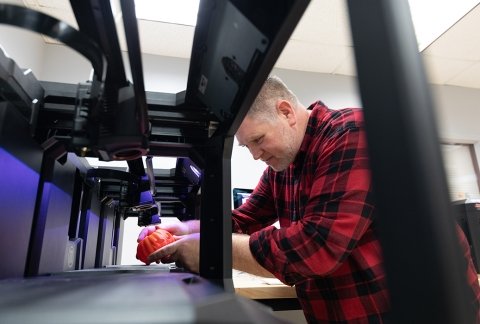 Professor Nick Paigo working with the 3d printers in the makerspace