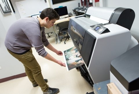 Student using the large-format printer in the media arts lab