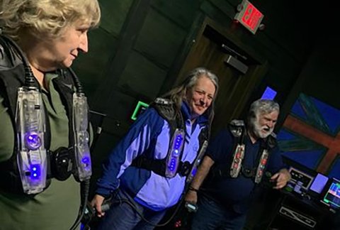 Veterans play laser tag on a bowling outing