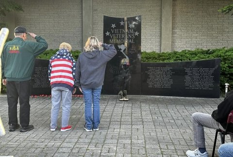 Veterans salute at the Vietnam Memorial