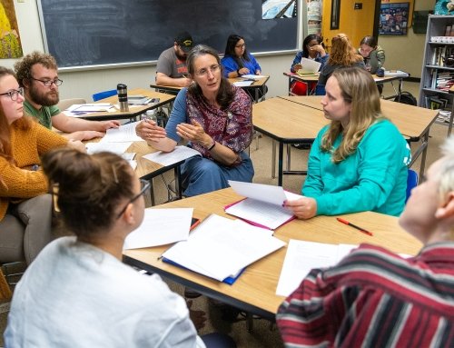 Professor Lale Davidson working with students in a creative writing class 