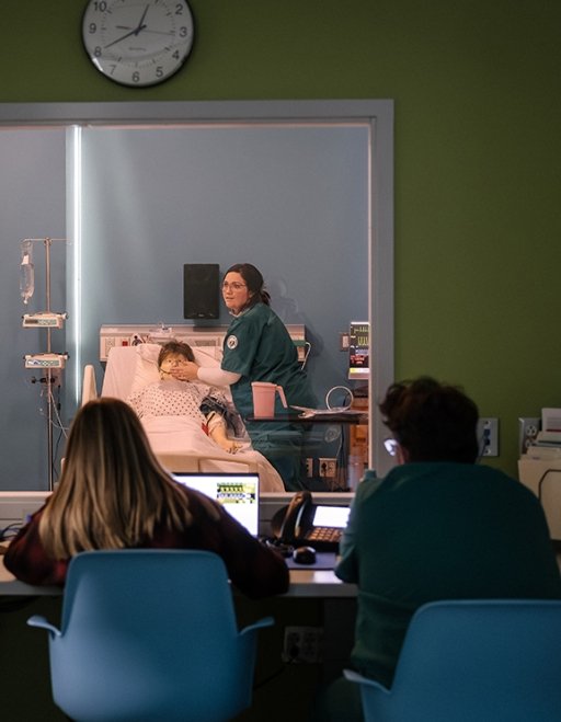 Nursing professors evaluate a student's work in a nursing simulation lab on SUNY Adirondack's Queensbury campus